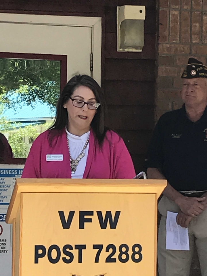 Brunswick County Chamber of Commerce President, Shannon Viera, provides opening remarks to the ribbon cutting ceremony as VFW Commander, Rick Arvonio, looks on.  